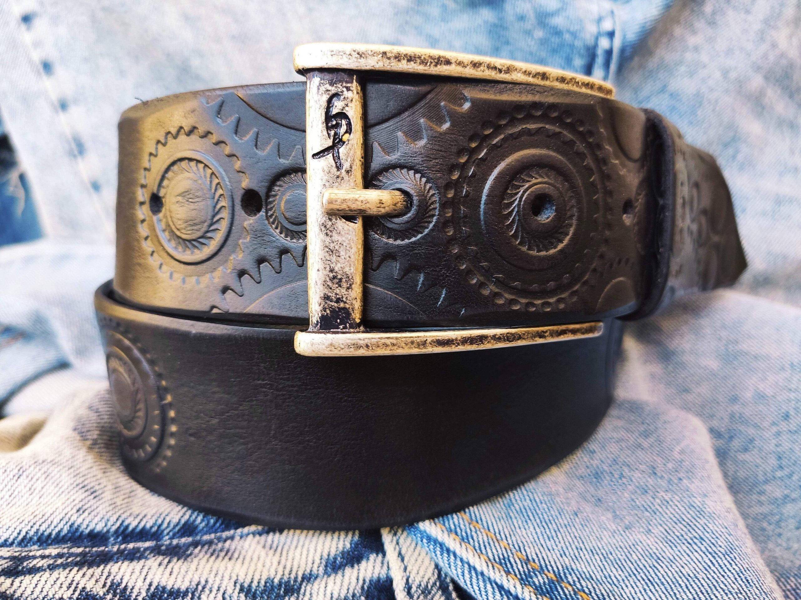 a handmade black leather belt embellished with stamps of motorcycle gear stunning belt for bikers the perfect gift for motorcycle lovers a handmade black leather belt embellished with stamps of motorcycle gear stunning belt for bikers the perfect gift for motorcycle lovers