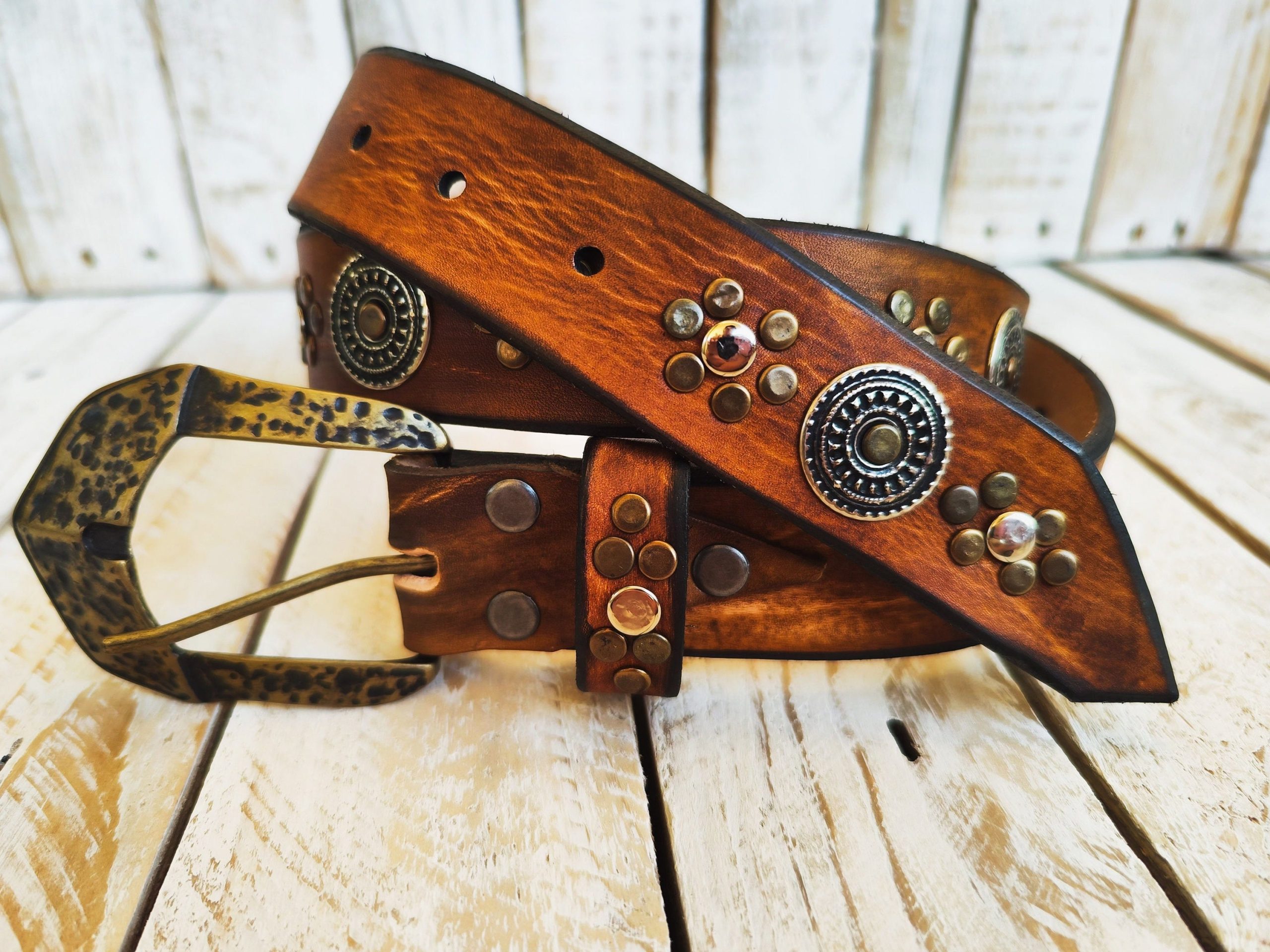 handcrafted brown leather belt with ishaor's unique design: light brown belt with gold and silver rivets and silver coin accents