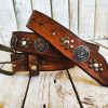 handcrafted brown leather belt with ishaor's unique design: light brown belt with gold and silver rivets and silver coin accents