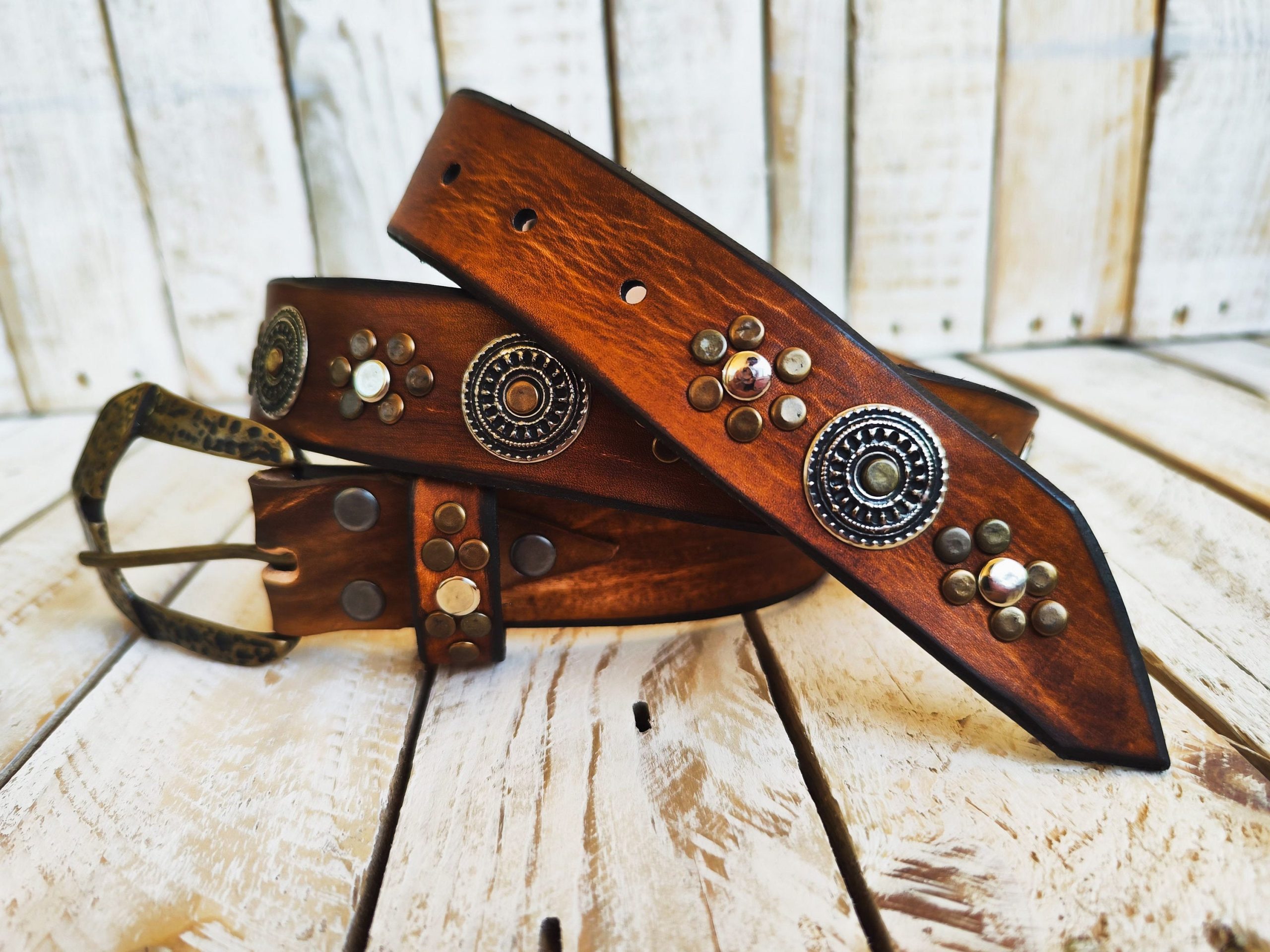 handcrafted brown leather belt with ishaor's unique design: light brown belt with gold and silver rivets and silver coin accents