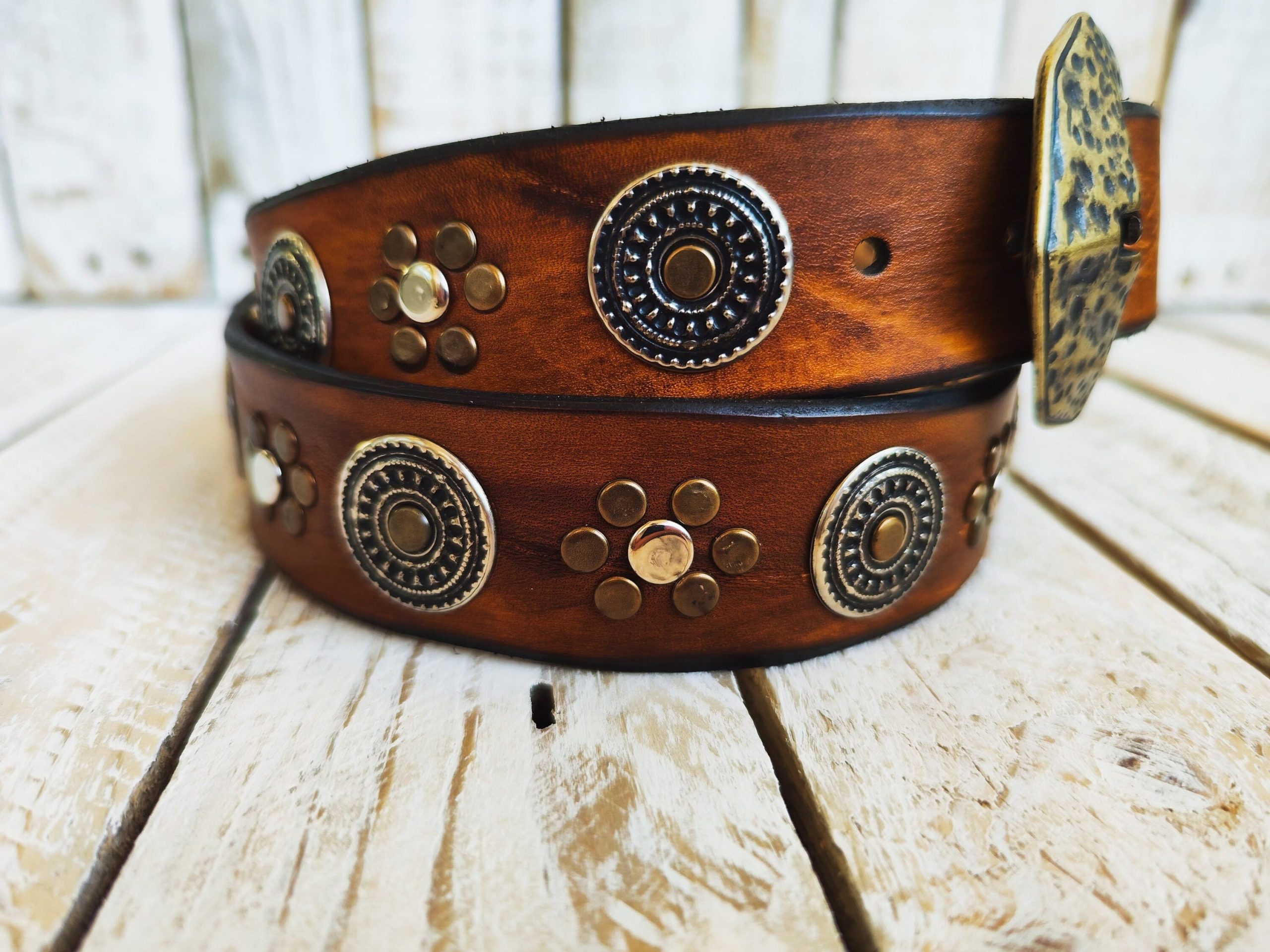 handcrafted brown leather belt with ishaor's unique design: light brown belt with gold and silver rivets and silver coin accents