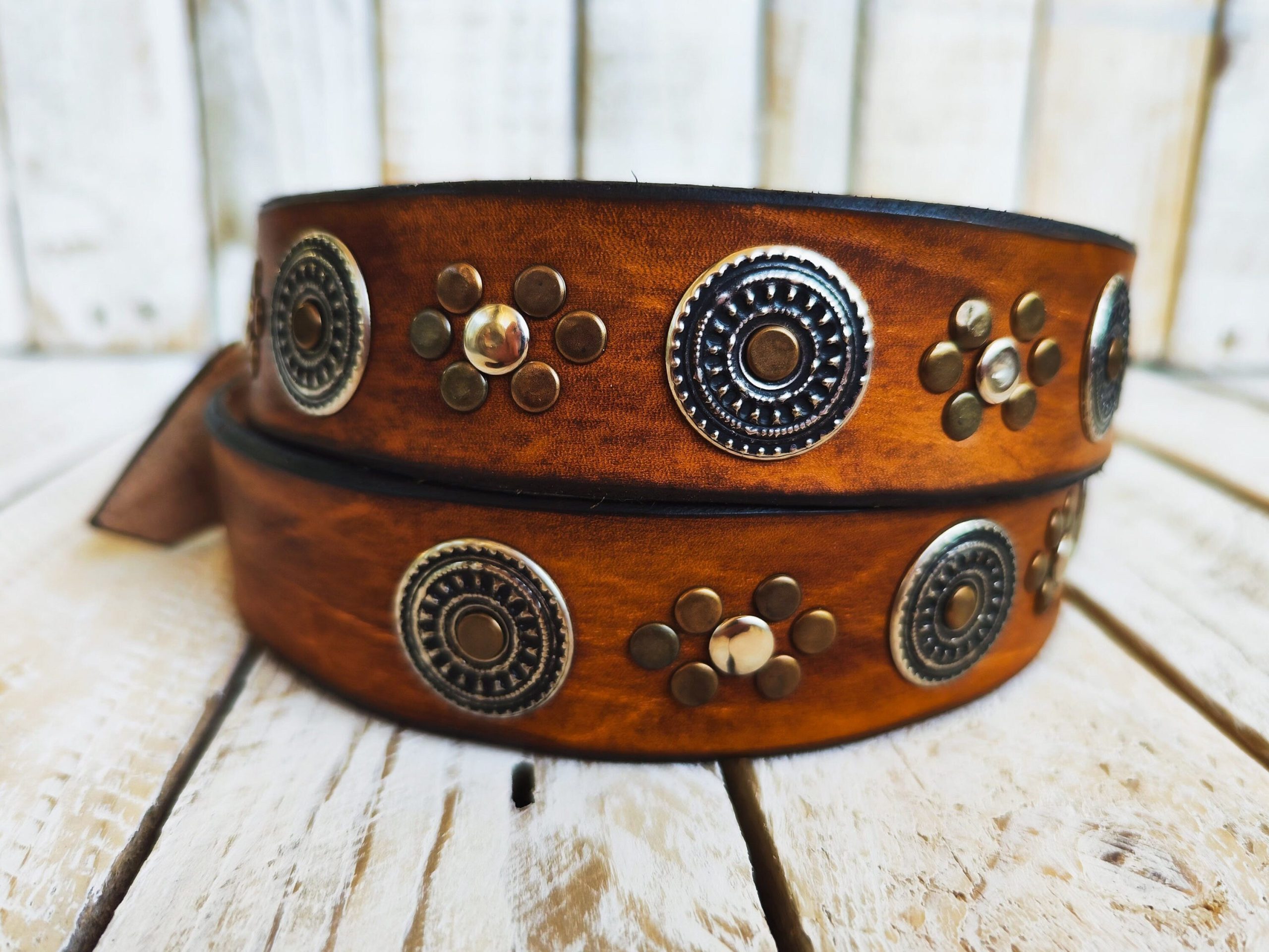 handcrafted brown leather belt with ishaor's unique design: light brown belt with gold and silver rivets and silver coin accents